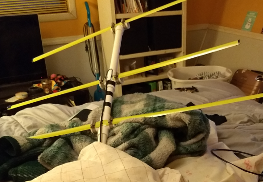 Yagi antenna propped up with two pillows and a blanket on my bed.